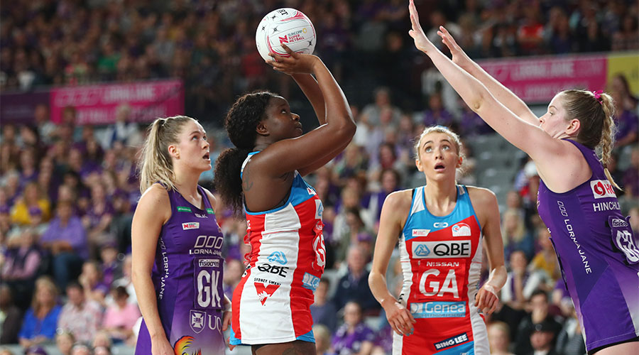 Swifts Sam Wallace shooting for goal with Firebirds Tara Hinchliffe defending