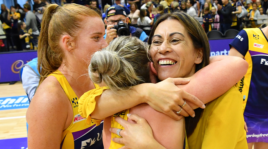 Lightning coach Noeline Taurua (centre) embraces Laura Scherian of the Lightning following their win of the Super Netball semi-final match between the Sunshine Coast Lightning and the NSW Swifts at the USC Stadium on the Sunshine Coast, Saturday, August 31, 2019. 