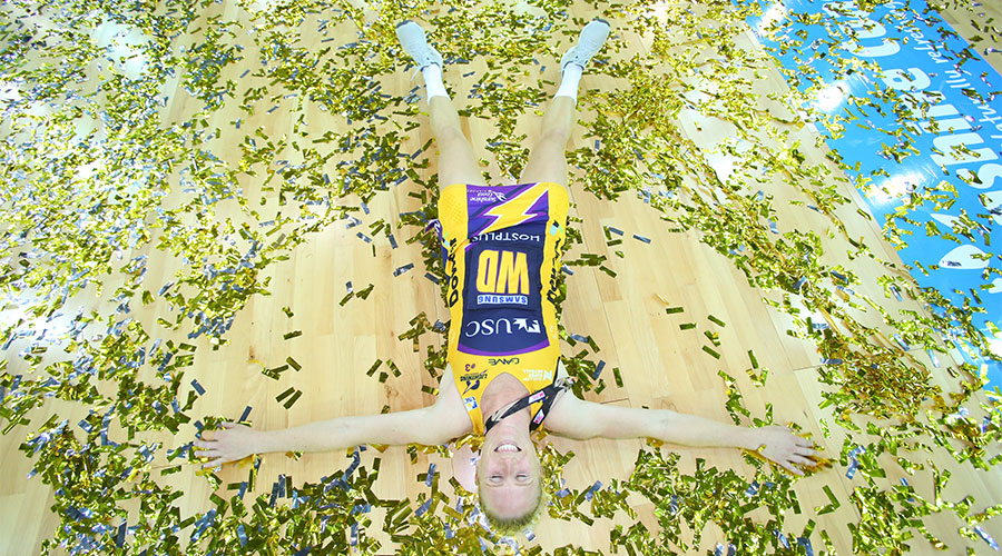 Laura Langman laying in confetti after the 2017 grand final win for Lightning