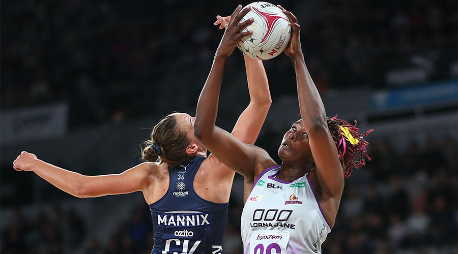 Emily Mannix and Romelda reaching up for the ball