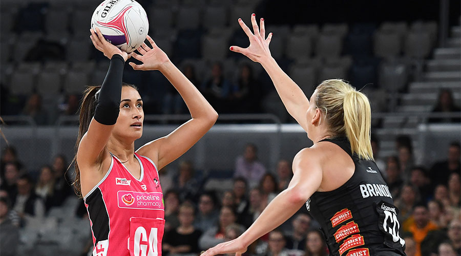 Maria Folau shooting for a goal with April Brandley defending