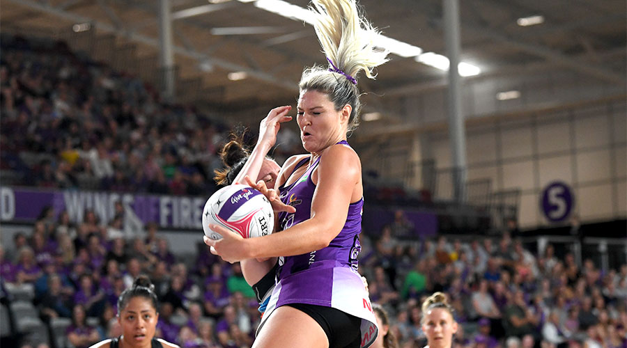 Gretel Tippett jumping in the air with the ball