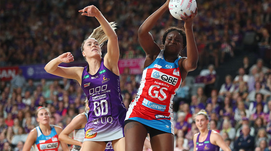Swifts Sam Wallace contesting for the ball with Firebirds Kim Jenner