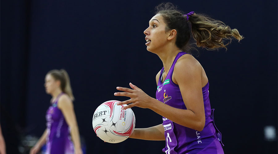 Jemmi MiMi from Firebirds with the ball