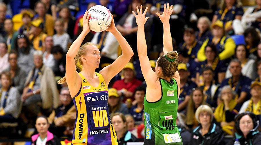 Madeline Mcauliffe looks to pass the ball with strong defence from the Fever WA