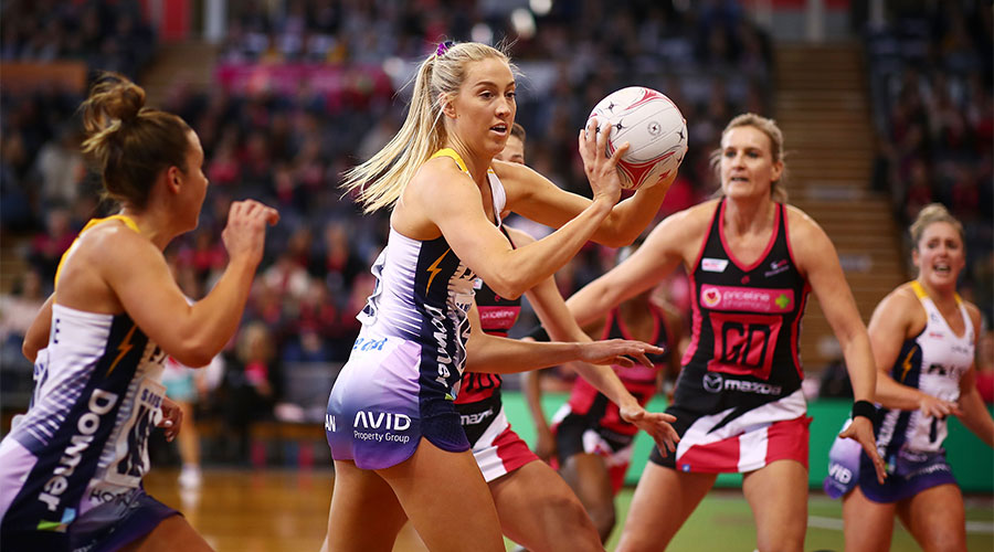 Cara Koenen looking to pass the ball whilst being defended by Thunderbirds players