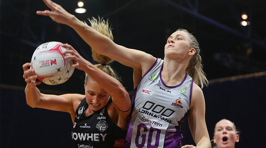 Kim Jenner trying to deflect the ball from Magpies shooter Erin Bell