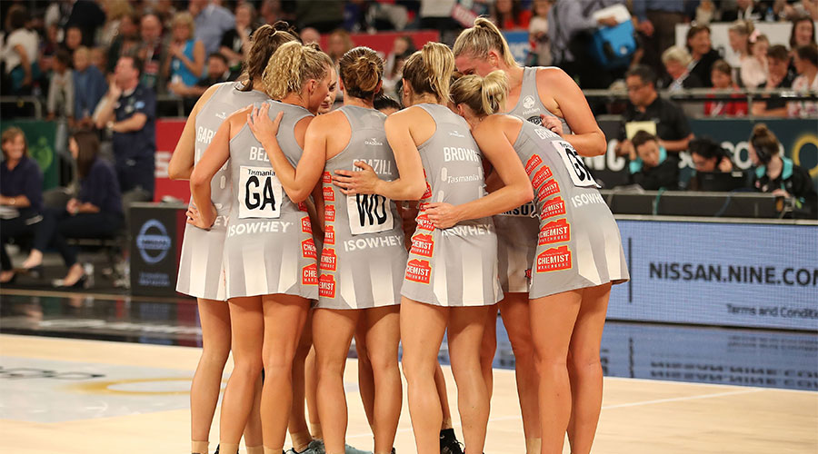 Magpies team mates in a huddle on court
