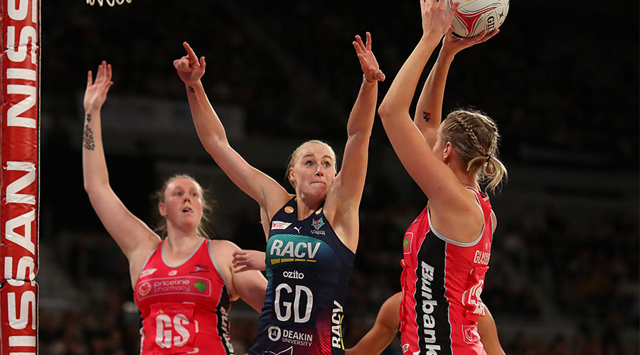 Jo Weston defending the ball from going into the goal against Thunderbirds shooters