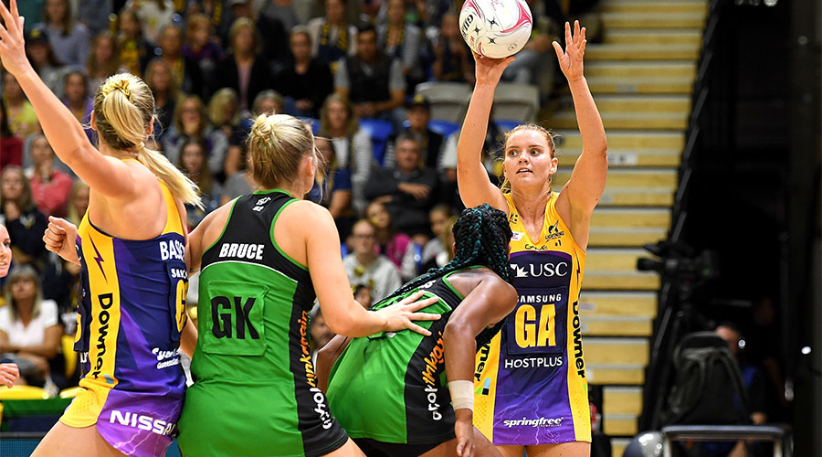 Steph Wood trying to pass the ball to Caitlin Bassett whilst being defended by Courtney Bruce and Stacey Francis from Fever
