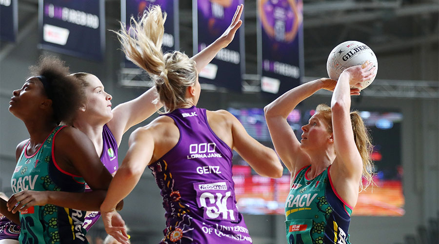 Tegan Philip shooting a goal with Firebirds players defending