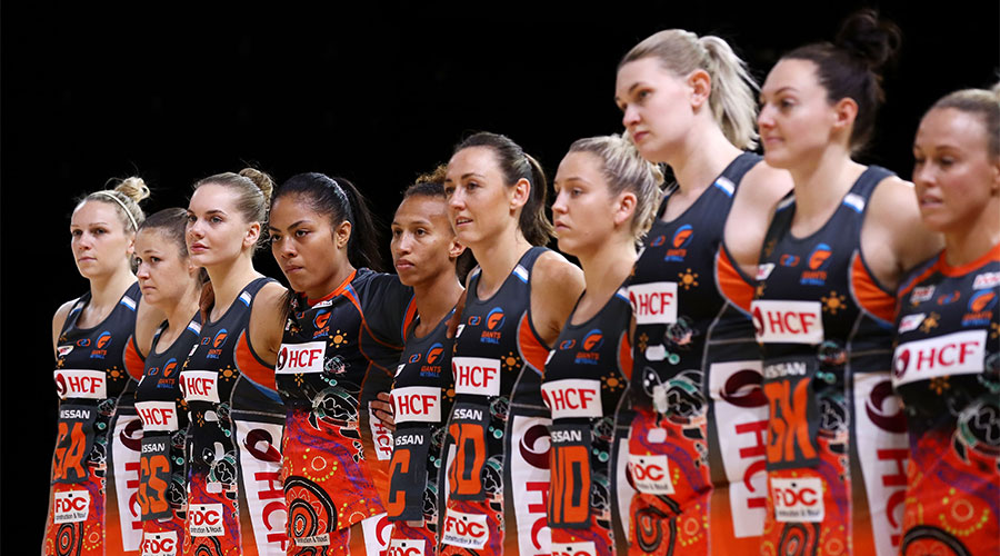 The Giants team lining up for the national anthem during Indigenous Round