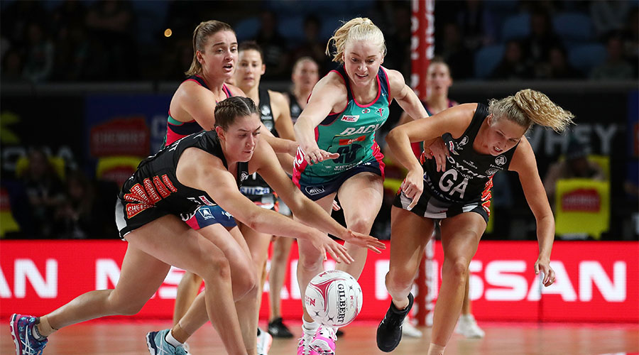Jo Weston and Liz Watson from the Vixens reaching for the ball along side Matilda Garrett and Erin Bell from the Magpies