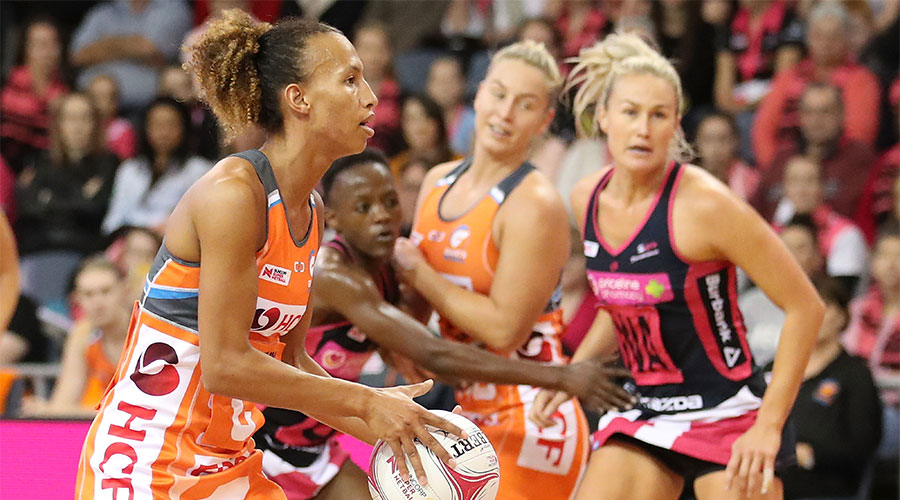 Serena Guthrie looking to pass the ball whilst being defended by Thunderbirds players