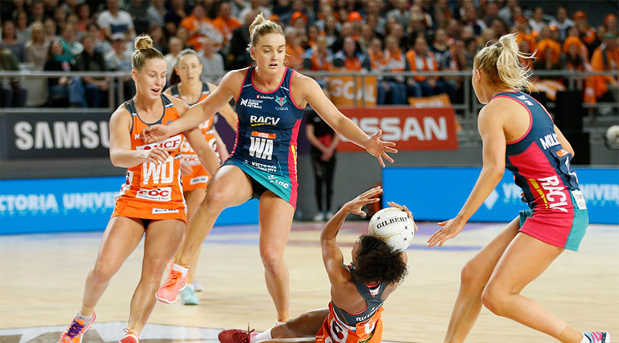 Serena Guthrie on the ground with the ball against Vixens players