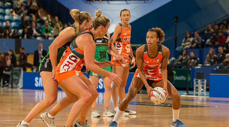 Serena Guthrie passing the ball to Kim Green whilst being defended by Fever players