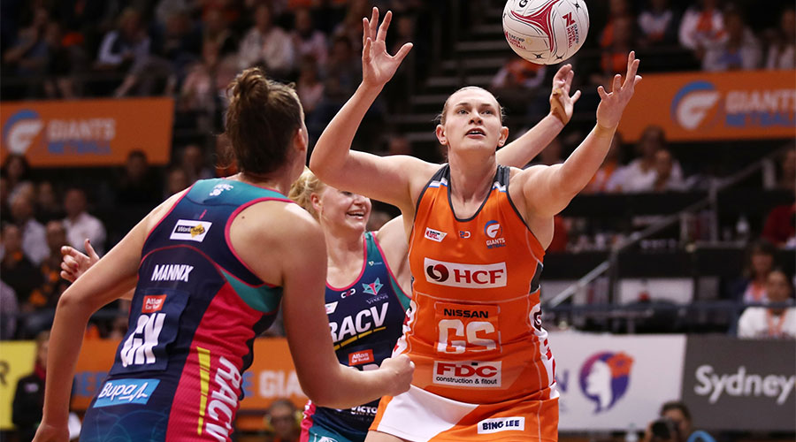 Kristina Brice reaching for the ball whilst being defended by Vixens players