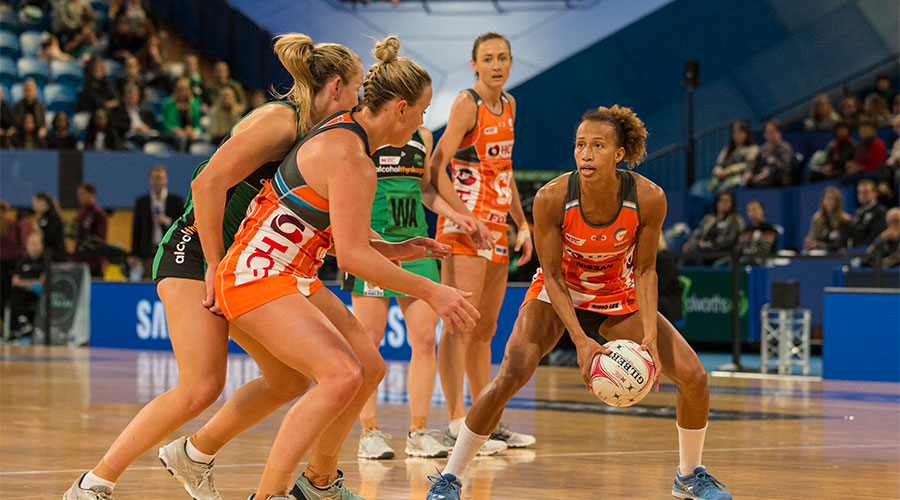 Serena Guthrie passing the ball to Kim Green whilst being defended by Fever players