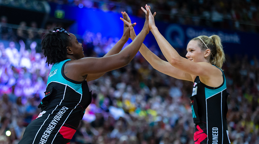Jo Harten and Sam Wallace celebrate a goal during the Netball Australia Bushfire Relief match in Sydney's Qudos Bank Arena.