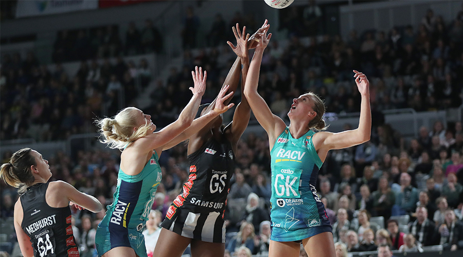 Jo Weston and Emily Mannix of the Melbourne Vixens contest a pass intended for Collingwood Magpies shooter Shimona Nelson