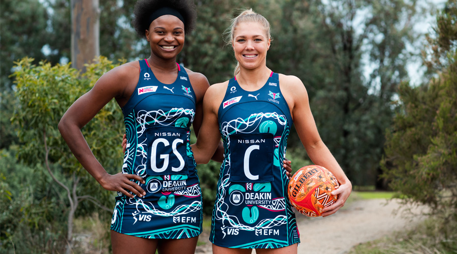Mwai Kumwenda and Kate Moloney of the Melbourne Vixens model their club's 2021 Indigenous Round dress.