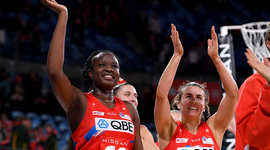 Sam Wallace and Maddy Proud gesture to supporters in the crowd following their win in the Super Netball Round 8 match between NSW Swifts and Queensland Firebirds at Ken Rosewall Arena in Sydney, Saturday, June 19, 2021. 