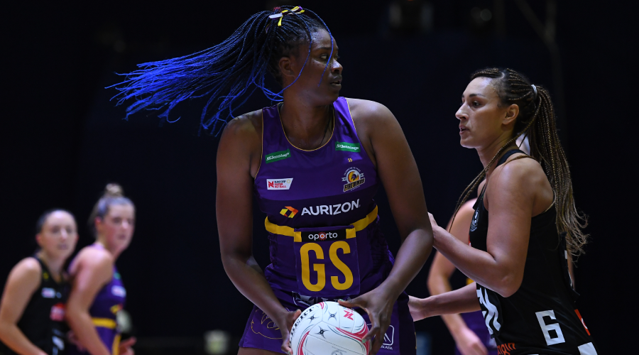 Romelda Aiken of the Firebirds (centre) and Geva Mentor of the Magpies in action during the Round 4 Super Netball match between the Collingwood Magpies and the Queensland Firebirds at the Silverdome in Launceston, Saturday, May 22, 2021