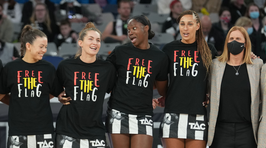Geva Mentor, Shimona Nelson and the Magpies stand as a team before the Round 10 Super Netball match between the Collingwood Magpies and GWS Giants at John Cain Arena in Melbourne, Sunday, July 11, 2021.