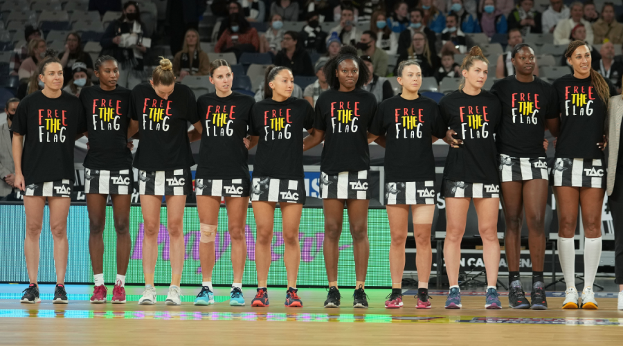Geva Mentor, Shimona Nelson, Nicole Richardson, coach of the Magpies and the Magpies stand as a team before the Round 10 Super Netball match between the Collingwood Magpies and GWS Giants at John Cain Arena in Melbourne, Sunday, July 11, 2021.