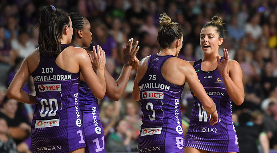 Lara Dunkley (right) of the Firebirds celebrates with team mates during the Round 3 Super Netball match between the Queensland Firebirds and West Coast Fever at Nissan Arena in Brisbane, Sunday, April 10, 2022.