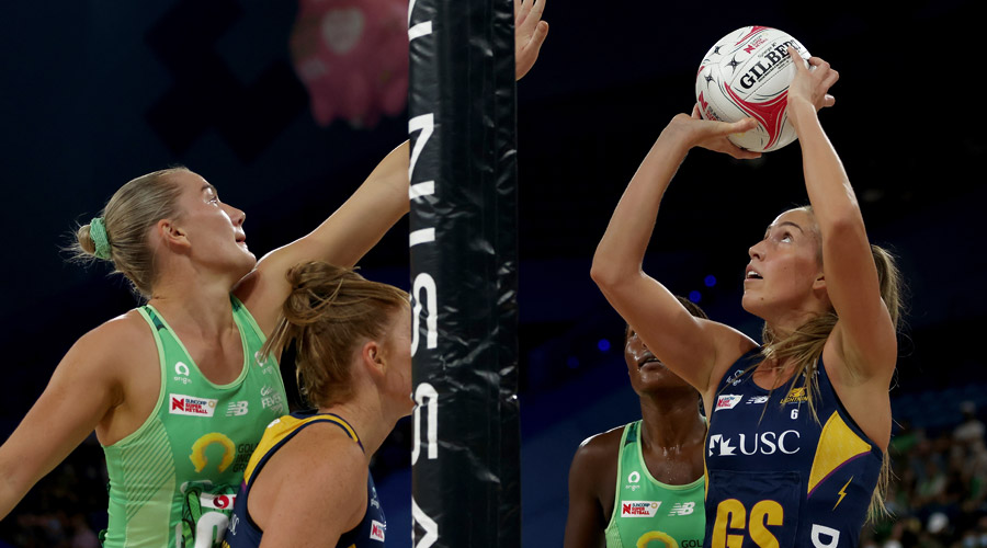 Cara Koenen lines up a shot against West Coast Fever defenders Courtney Bruce and Sunday Aryang