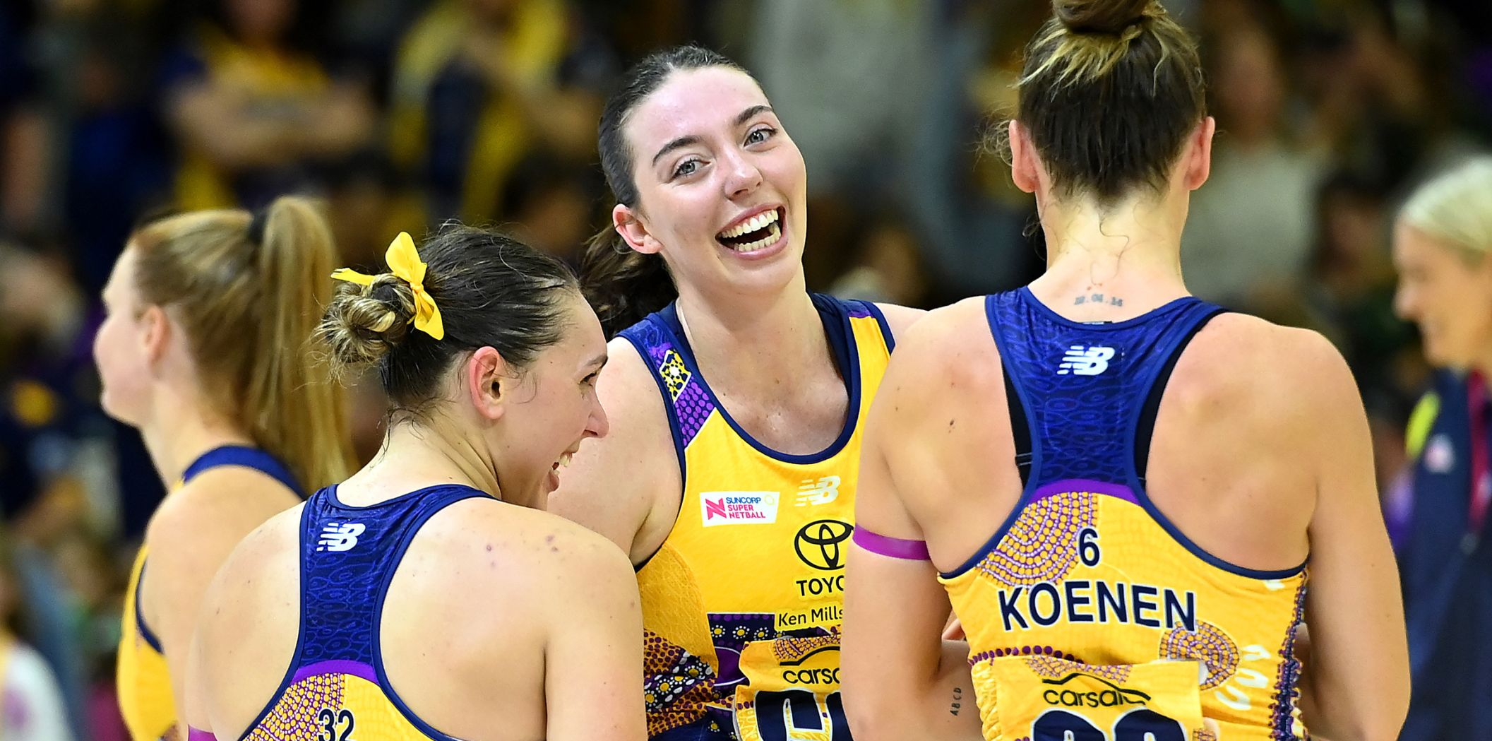 Ashleigh Ervin smiles with teammates after a victory